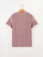 Pink eyelet embroidered short-sleeve blouse with cutout details on sleeves.