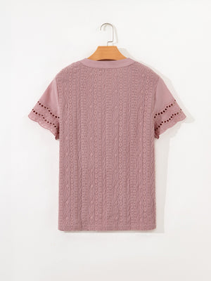 Pink eyelet embroidered short-sleeve blouse with cutout details on sleeves.