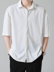 Men's white short sleeve button-down shirt with a relaxed fit and spread collar.