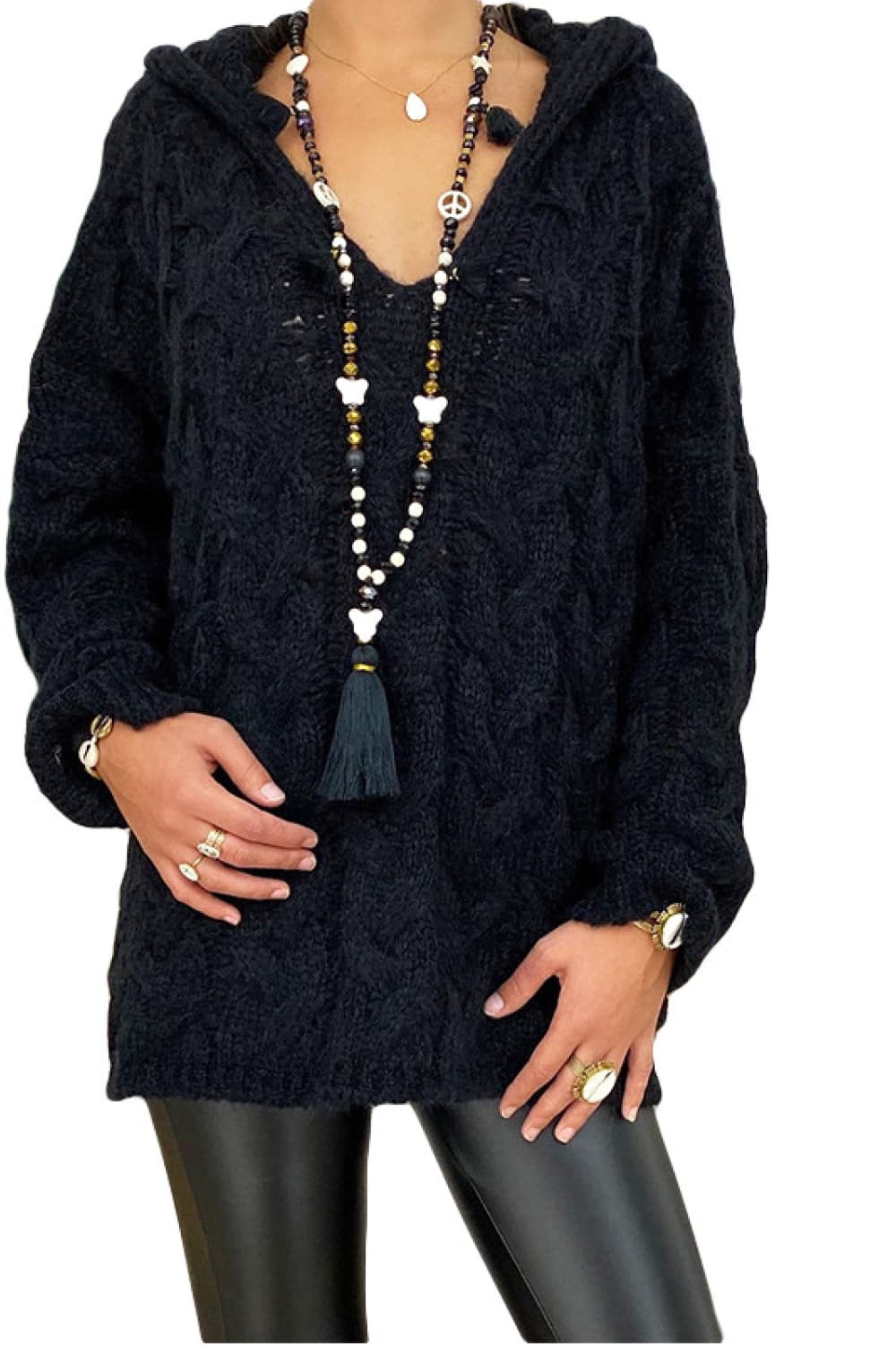 Black cable knit hooded cocoon sweater with V-neck and long sleeves.