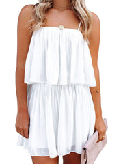 White tiered cami romper with delicate straps and a ruffled hem.