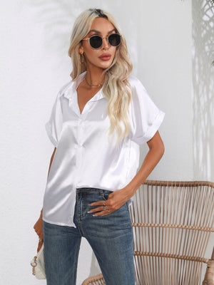 White satin boxy sleeve blouse with button-down front and cuffed sleeves.
