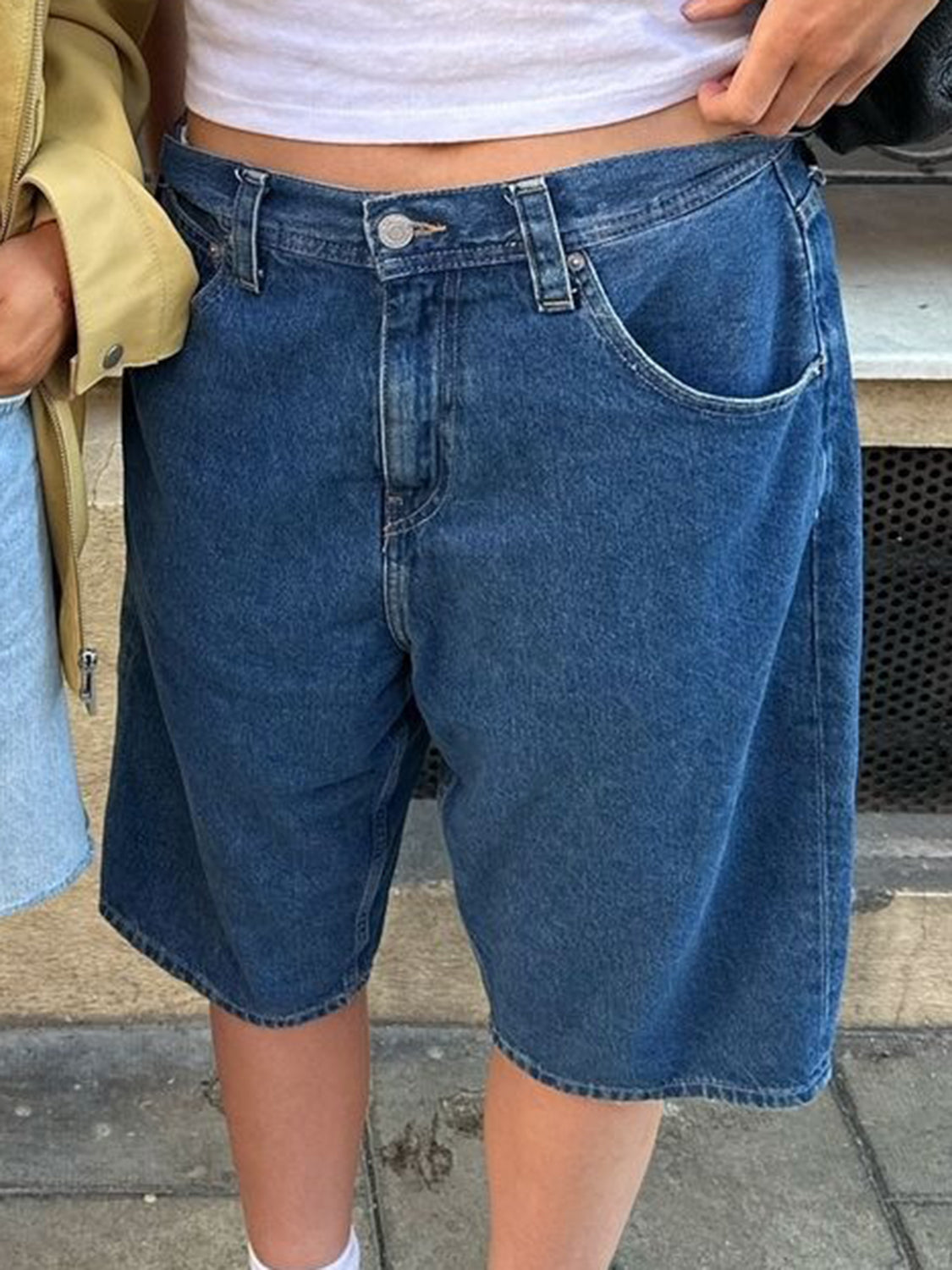 Culotte-cut denim bermuda shorts in Dusty Blue with buttoned fly and casual styling.