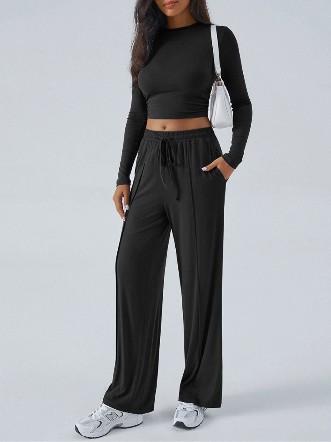 Black ribbed knit crop top and wide leg pants set with drawstring waist.
