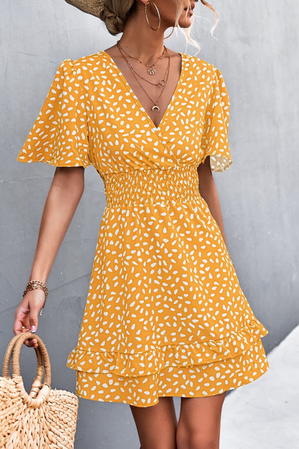Mustard smocked waist mini dress with flutter sleeves and white speckle print.
