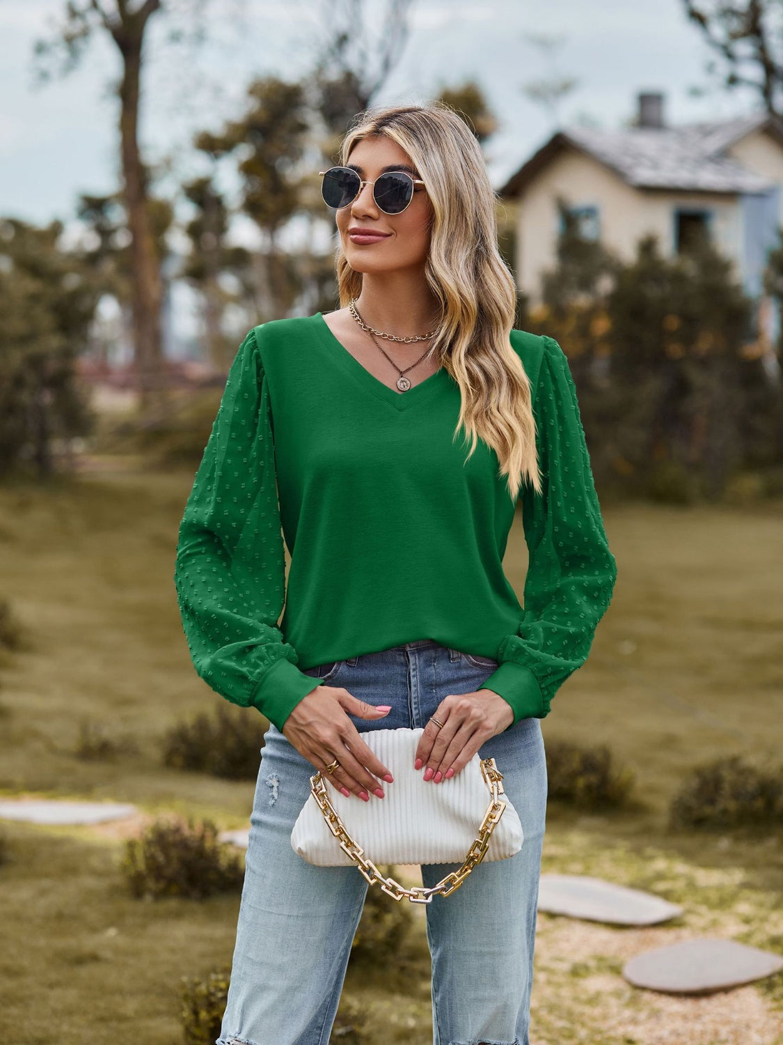Green V-neck blouse with Swiss dot long sleeves and a relaxed fit.
