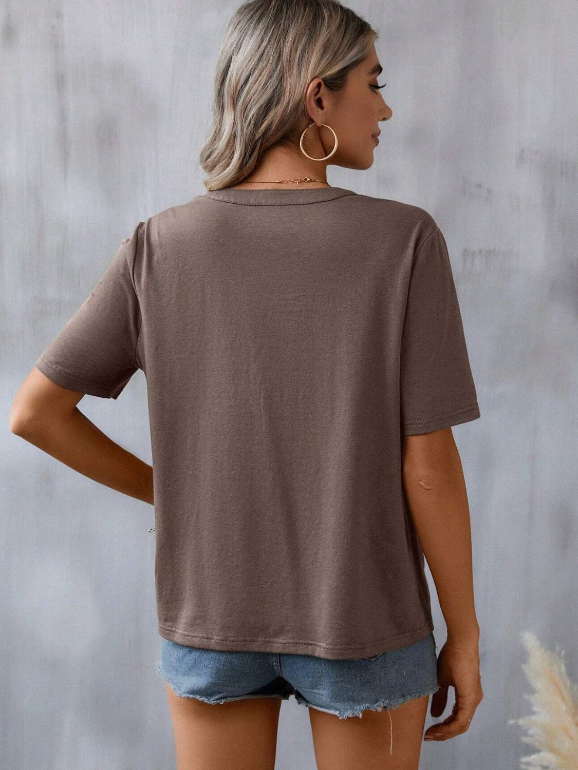 Taupe V-neck tee with short sleeves and crochet trim detail on the neckline.