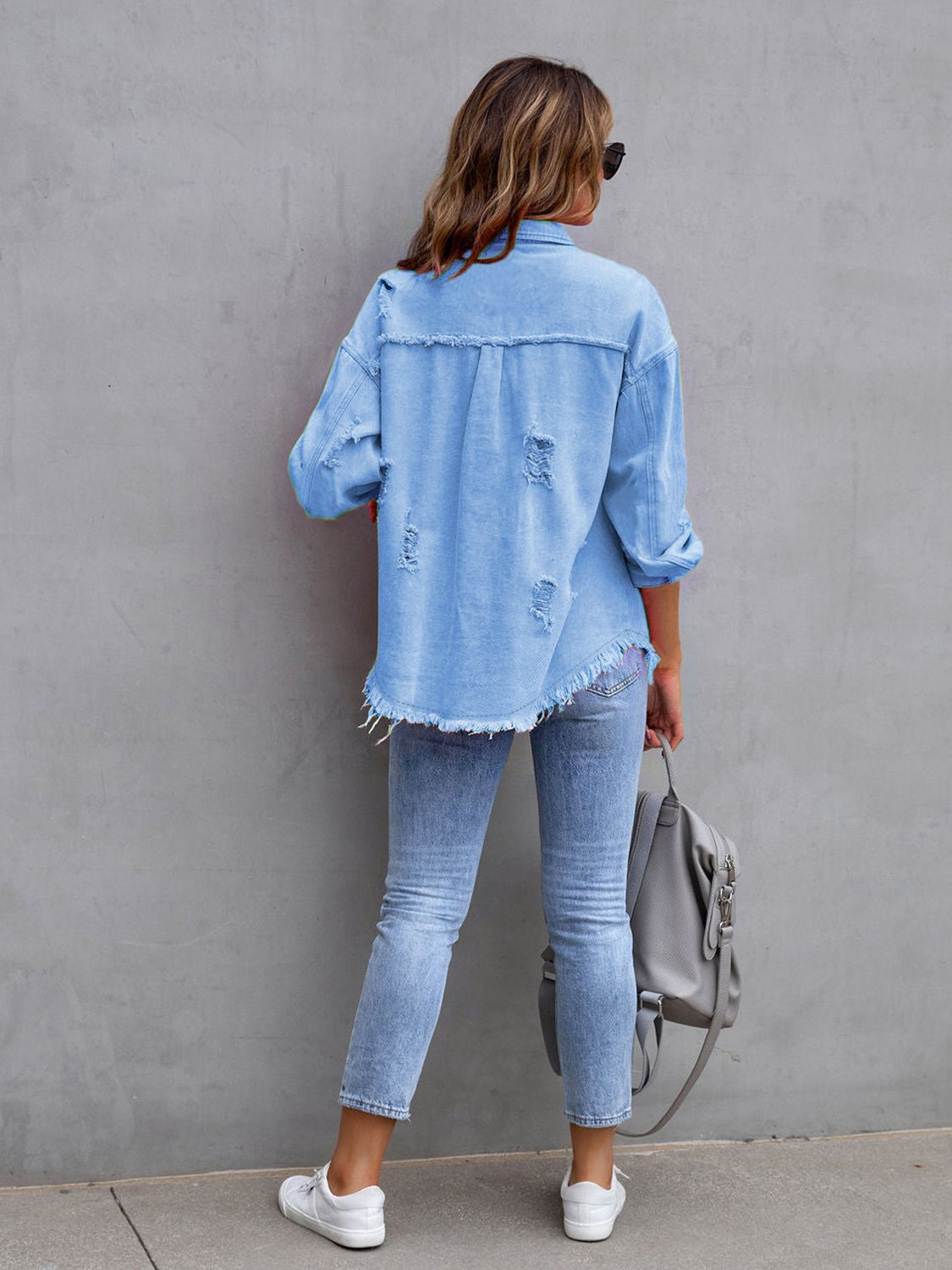Light blue distressed denim shacket with frayed hem and cuffs.
