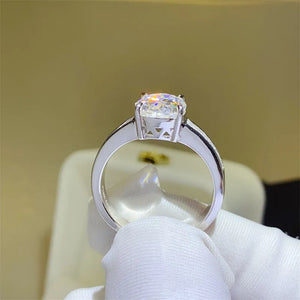 Silver band ring with oval cut diamond and baguette accents