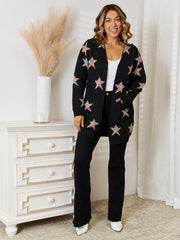 Black knit cardigan with colorful starburst pattern and pockets.