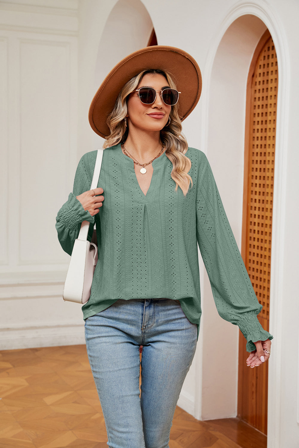 Gum Leaf eyelet detail poet sleeve blouse with V-neck and smocked cuffs.