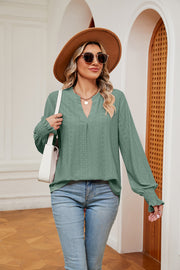 Gum Leaf eyelet detail poet sleeve blouse with V-neck and smocked cuffs.
