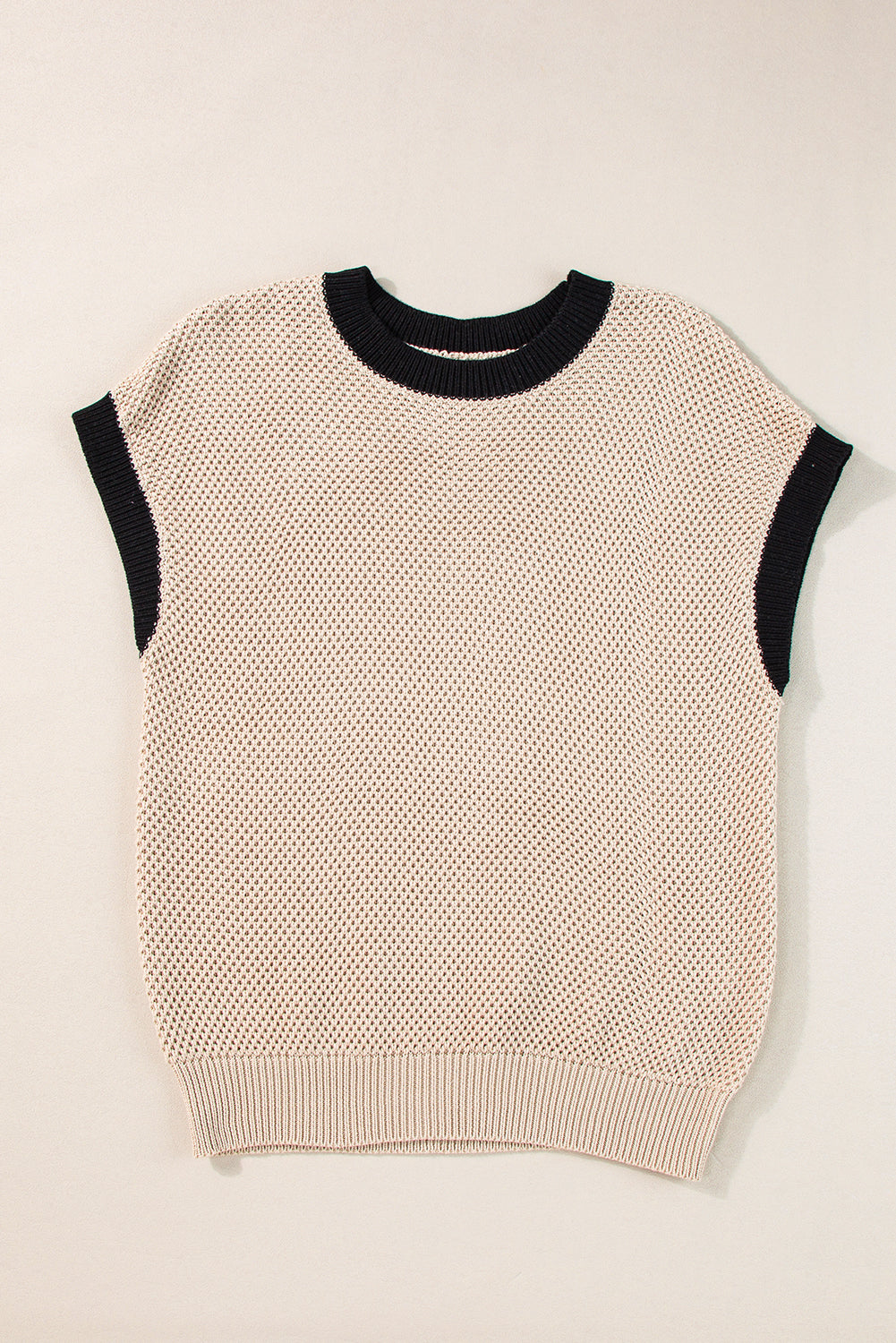 Beige knit cap sleeve top with black trim neckline and armholes.