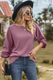 Lilac waffle knit eyelet raglan sleeve top with crew neck and cuffed sleeves.