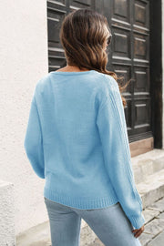 Light blue acrylic V-neck sweater with vertical ribbing on sleeves and body.