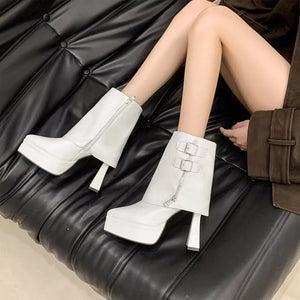 White ankle boots with pointed toe, block heel, side zipper, and double buckle straps.