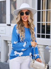 Sky blue knit pullover sweater with white angel wing motif, crew neck, long sleeves.
