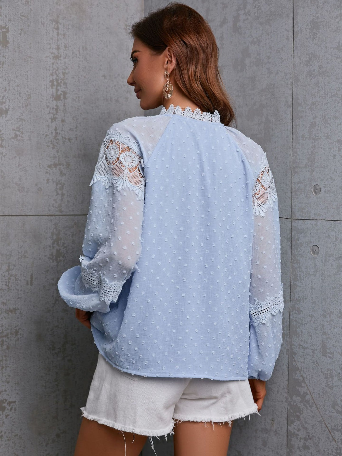 Textured Misty Blue blouse with lace trim on sleeves and neckline.