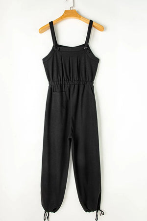Black waffle knit wide leg jumpsuit with adjustable straps and drawstring waist