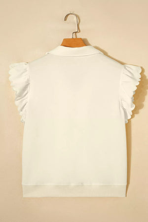 White cotton blouse with ruffled cap sleeves, stand-up collar, and zip detail.