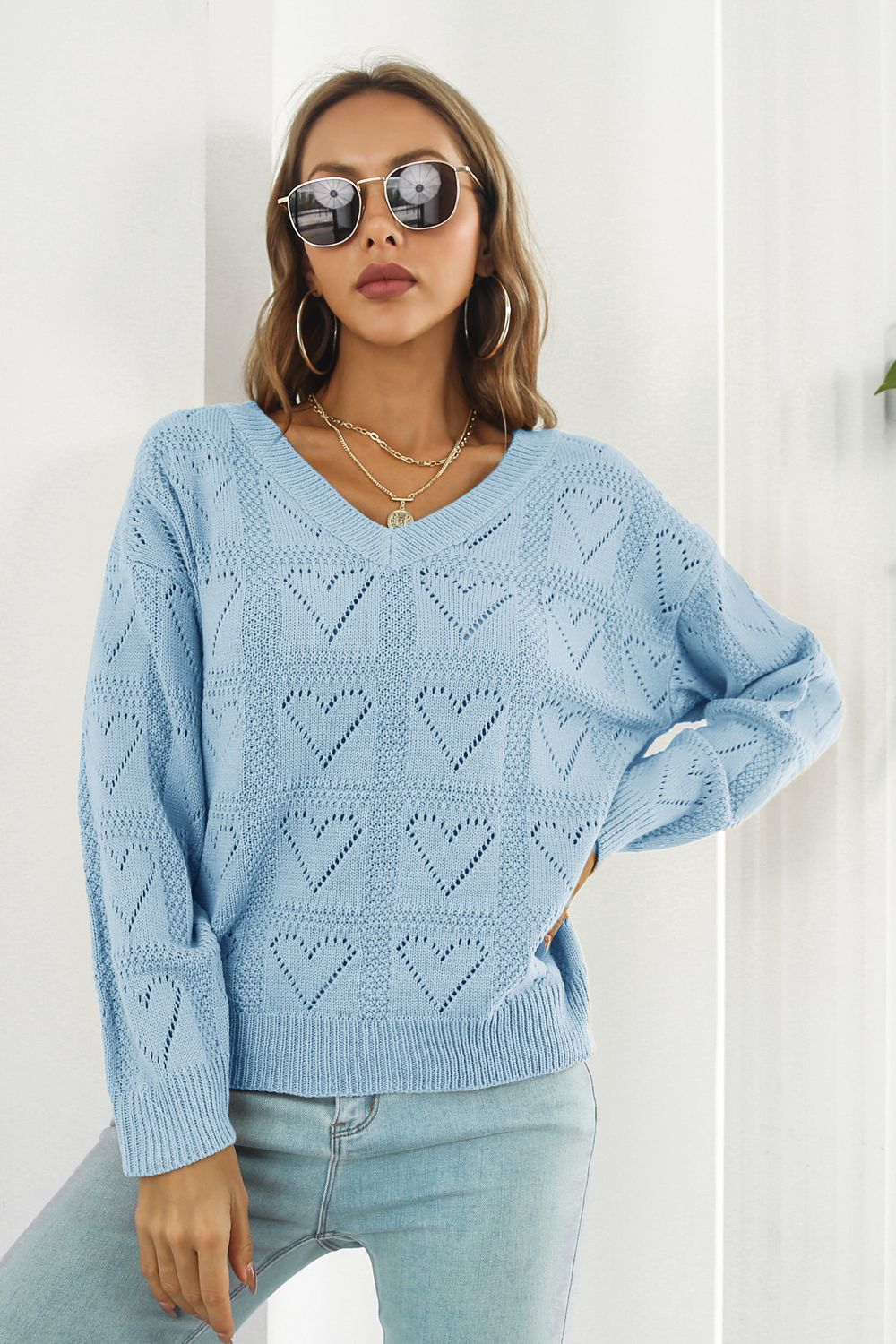 Light blue V-neck knit pullover sweater with allover heart stitch pattern.