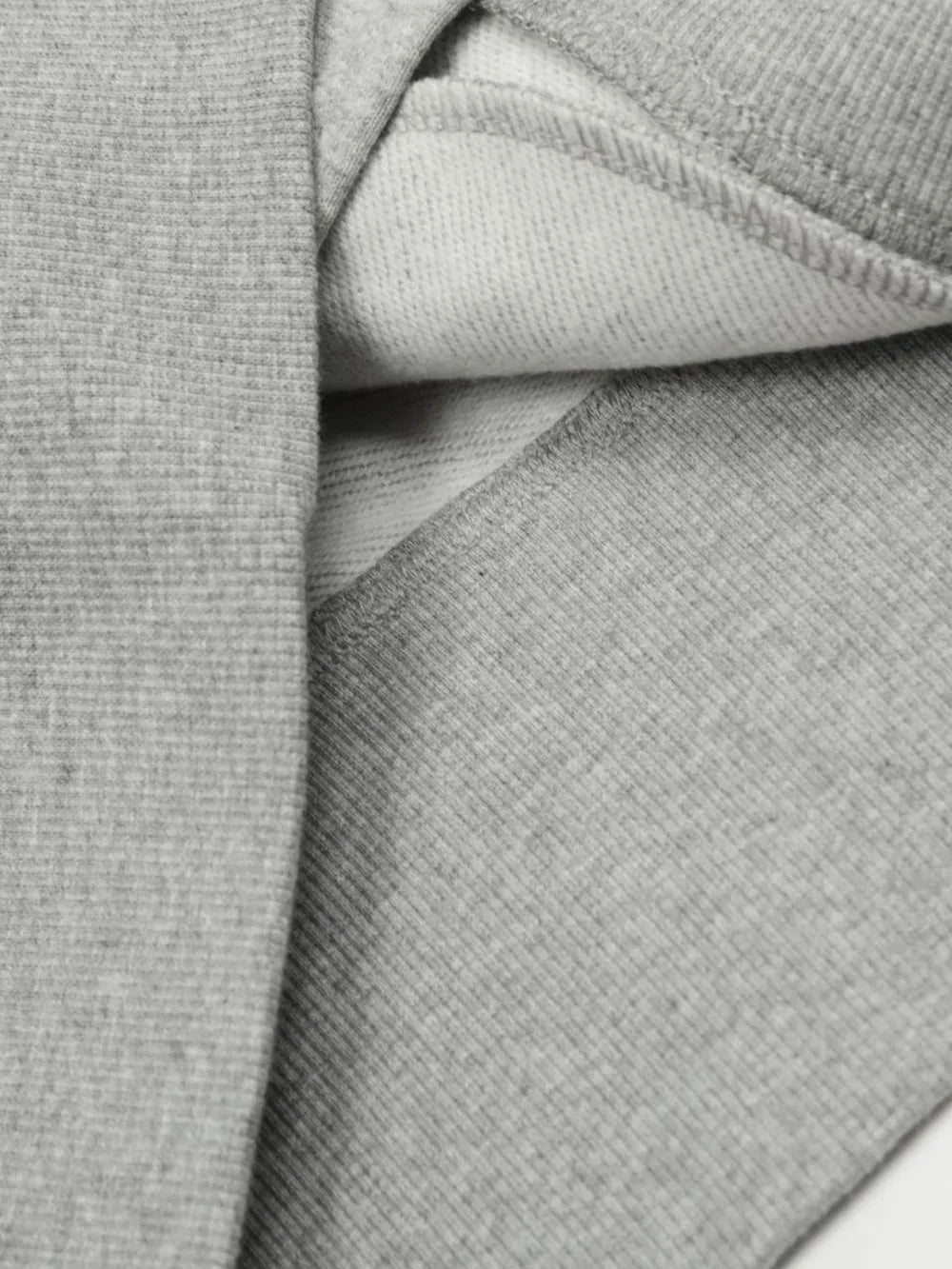 Gray zip-up sweatshirt with sculpted seam detail and ribbed texture.