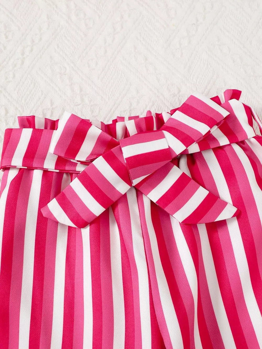 Pink and white striped pants with a bowknot detail and ruffled waist.