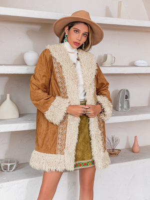 Caramel suede coat with shearling trim and embroidered details.