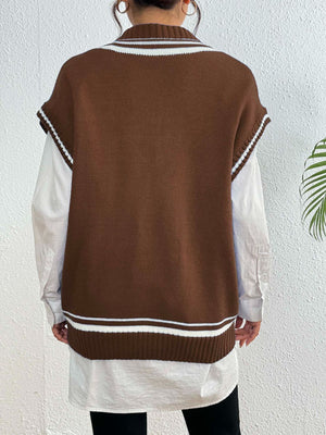 Chocolate acrylic knit vest with contrast trim and ribbed hem, styled over a white shirt.