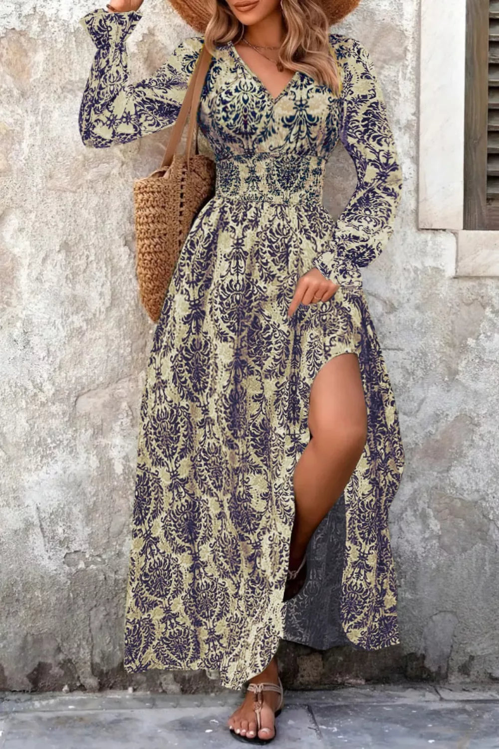 Maxi dress with bishop sleeves, cinched waist, and high slit in a navy and sage print.