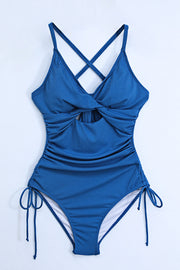 Ribbed one-piece swimsuit in Peacock Blue with a cutout, tie detail, and adjustable side ties.