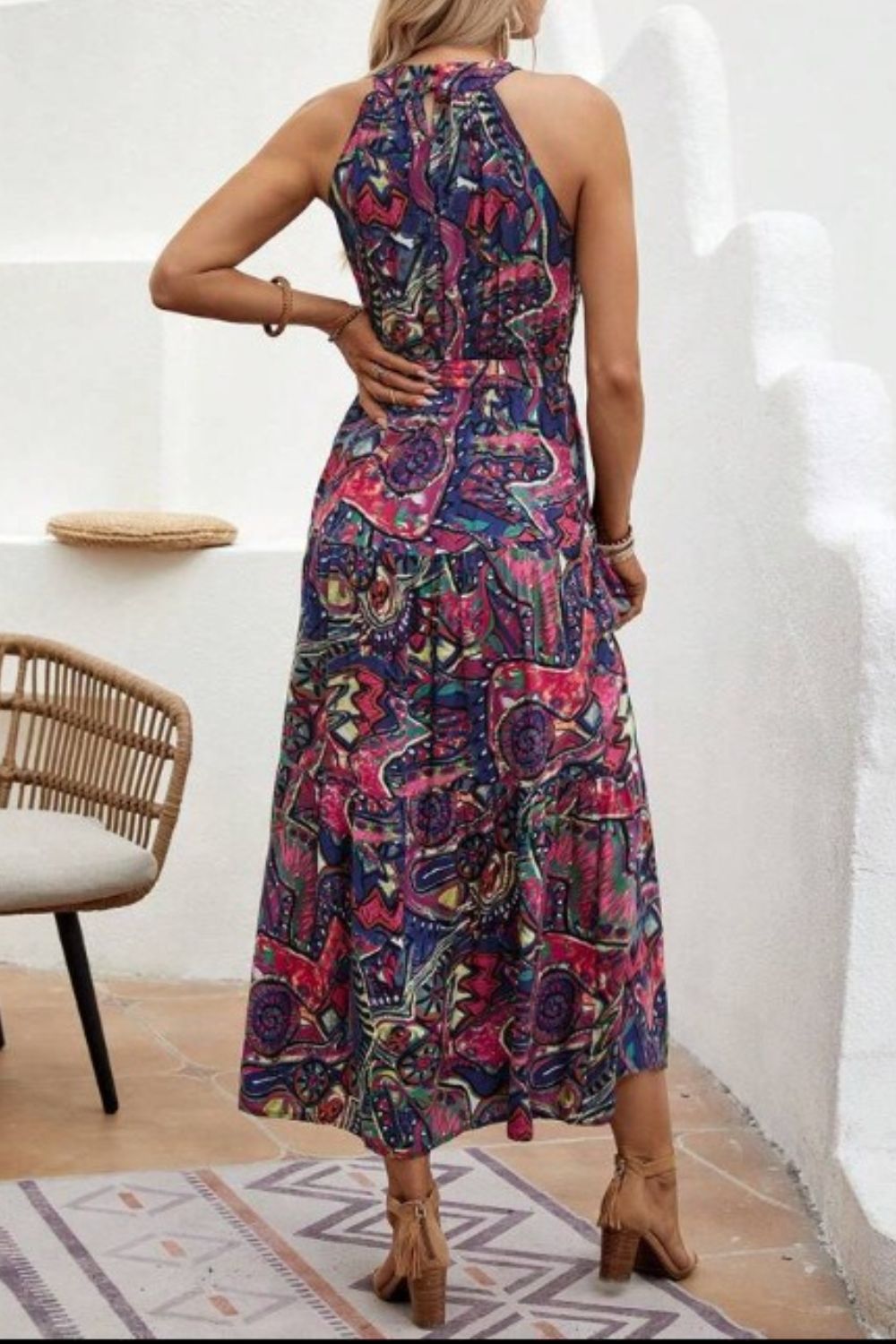 Halter neckline maxi dress with a vibrant paisley print and a cinched waist.