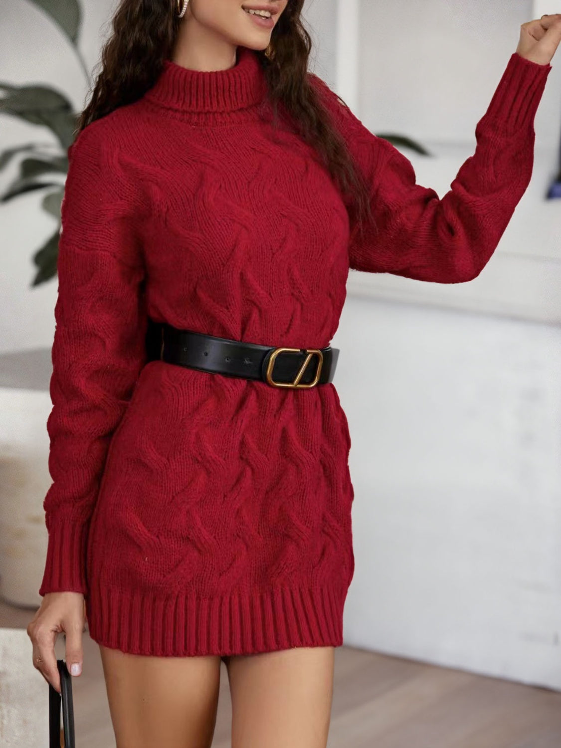 Burgundy cable knit turtleneck mini dress with long sleeves and a black belt.