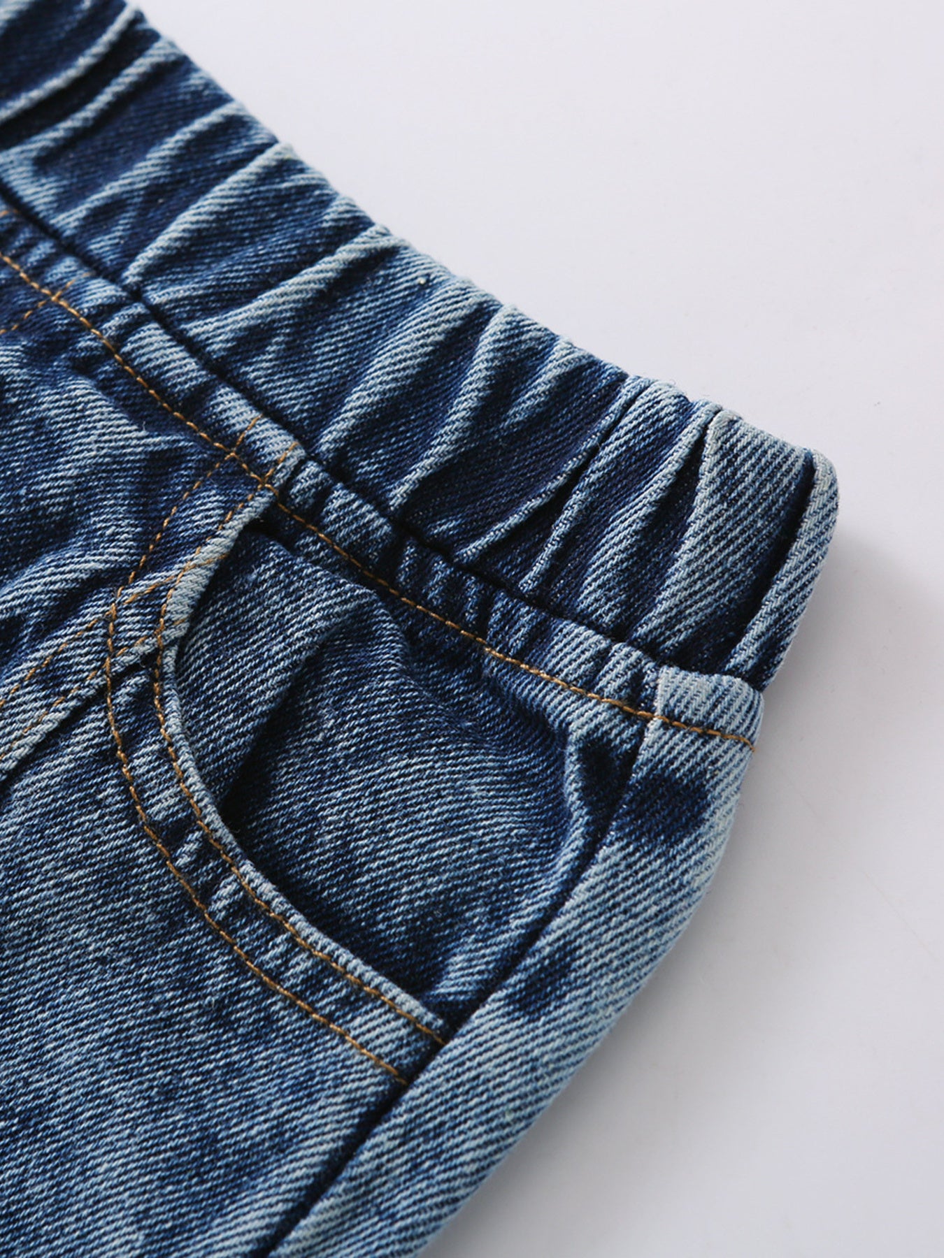 Toddler blue denim jeans with elastic waistband and pocket detail.
