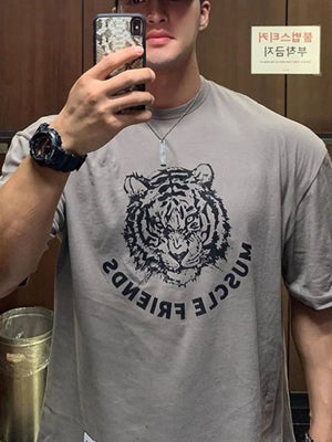 Gray oversized tee with a black tiger graphic and text.