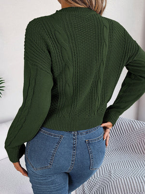 Army green cable knit sweater with textured sleeves and crew neck.