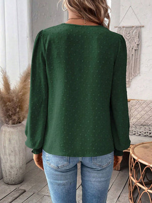 Dark Green textured blouse with puff sleeves and ruffled cuffs.