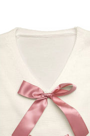 Beige V-neck knit cardigan with satin bow detail
