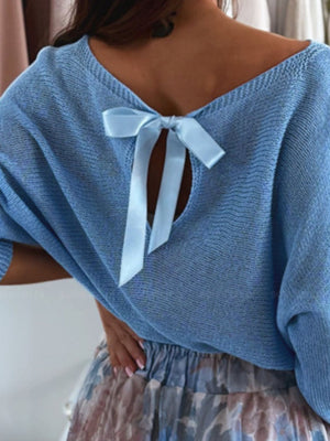 Sky blue knit sweater with batwing sleeves and a bow-tie back detail.