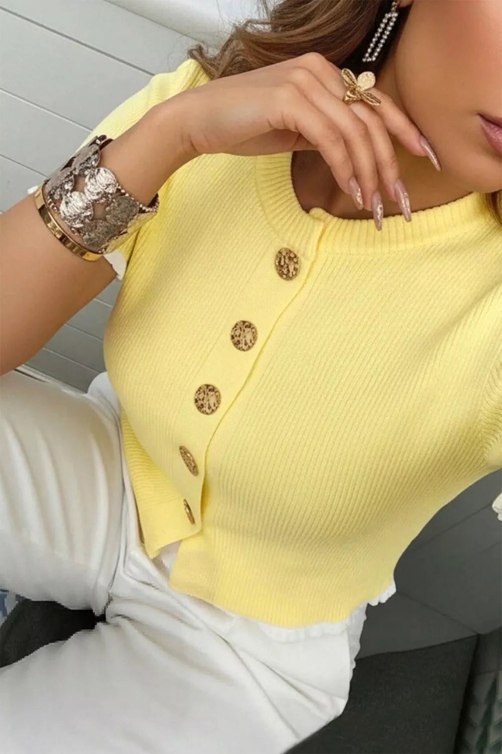Yellow ribbed short sleeve cardigan with gold buttons and frilled trim detail.