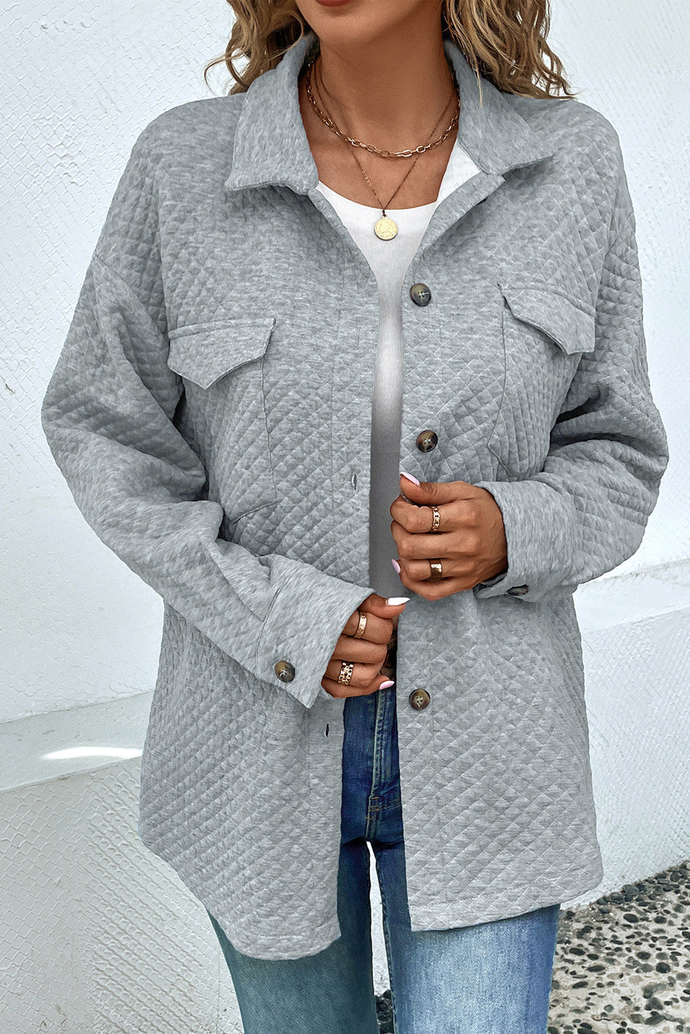 Quilted overshirt in grey with patch pockets and button front.