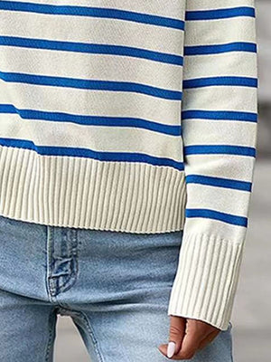 Striped knit sweater with blue and white horizontal stripes, ribbed cuffs and hem.