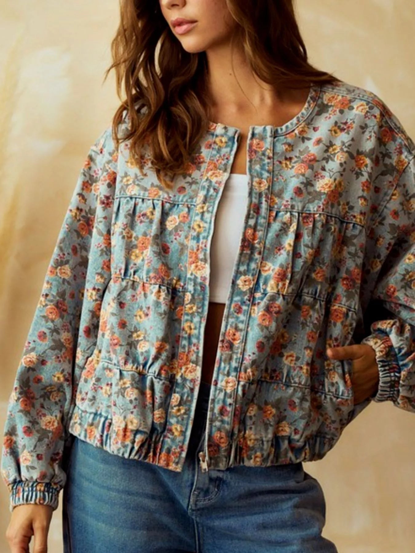 Cropped denim trucker jacket with floral print, round neck, and elasticated cuffs.