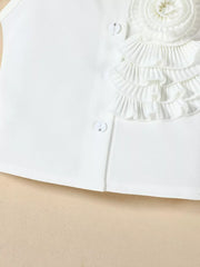 White ruffled top with decorative button detail and layered ruffles.