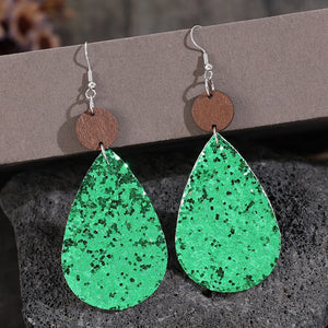 Green glitter teardrop earrings with wood accent detail.