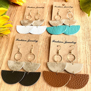 Textured leather half-moon earrings in white, aqua, black, and caramel with metallic tops.