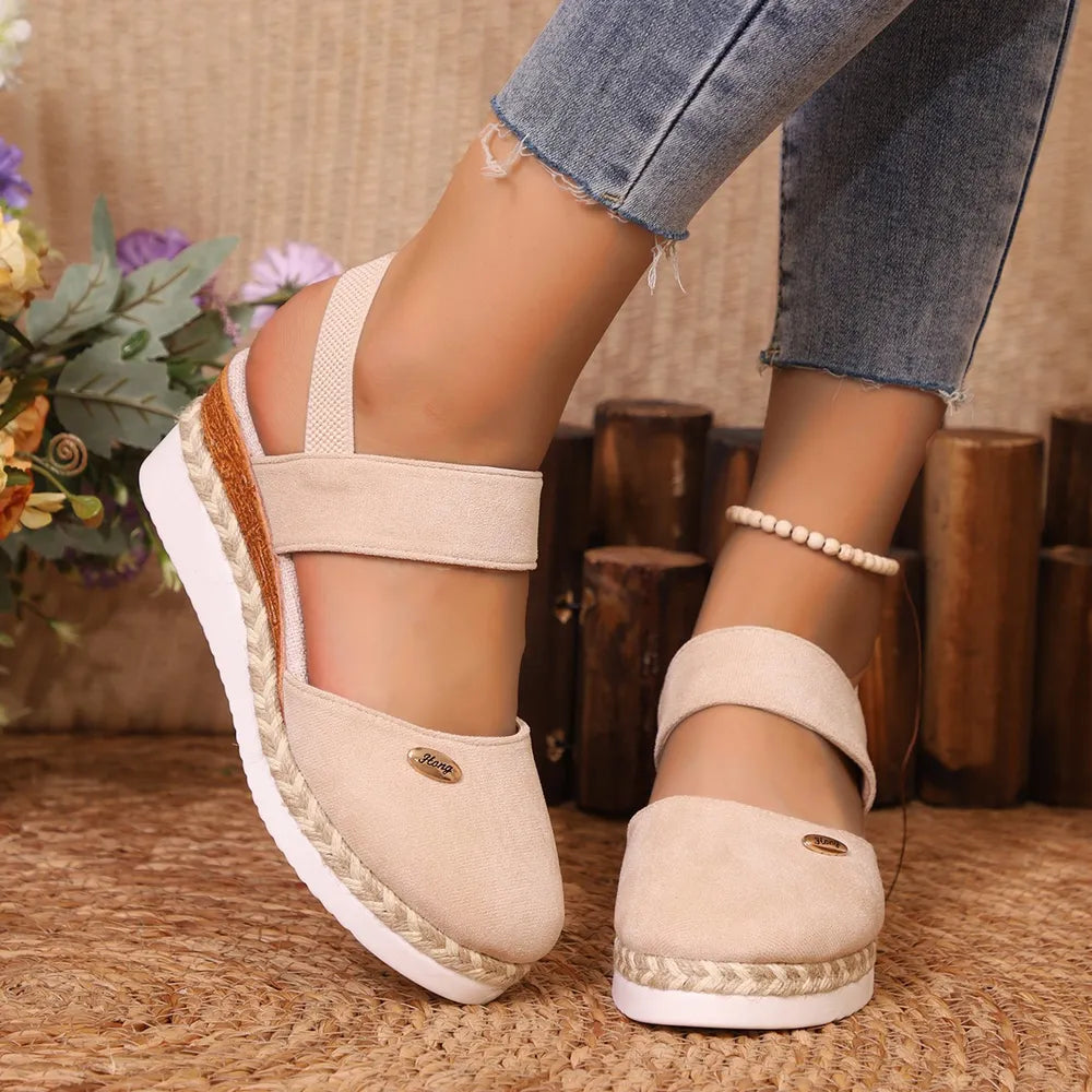 Eggshell espadrille wedge slingback sandals with elastic straps and braided espadrille sole detail.