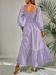 Purple midi dress with smocked bodice, puff sleeves, and tiered ruffle hem.