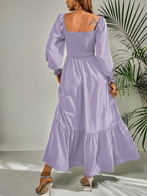 Purple midi dress with smocked bodice, puff sleeves, and tiered ruffle hem.