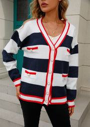 Navy and white striped knit cardigan with pearl buttons and red trim.